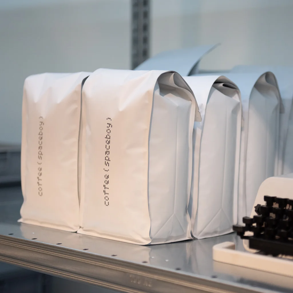 A photo of coffee (spaceboy) bags on a shelf A photo of coffee (spaceboy) bags on a shelf